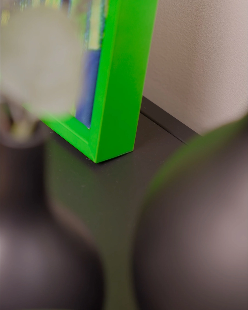 Detailopname van de hoek van de baklijst Jill in fel neongroen voor canvasdoeken in een huiselijke sfeer